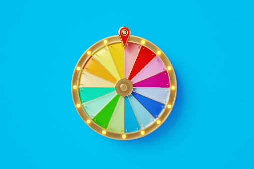 Colorful wheel of fortune on blue background. Horizontal composition with copy space. Directly above.