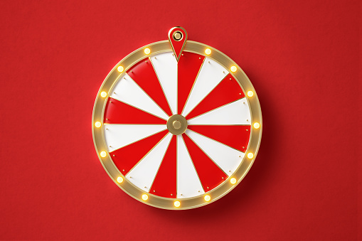 Wheel of fortune on red background. Horizontal composition with copy space. Directly above.