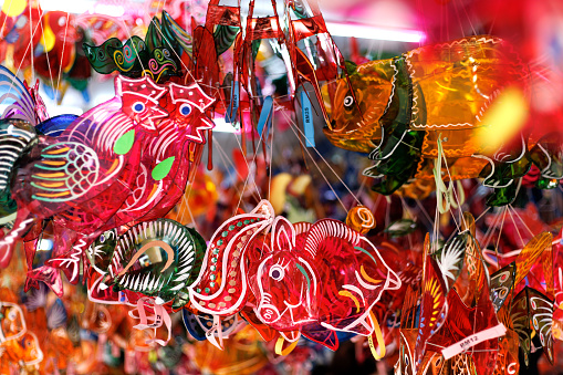 Multi colored Animal themes Lanterns hanging on a stand selling at a Asian market stall