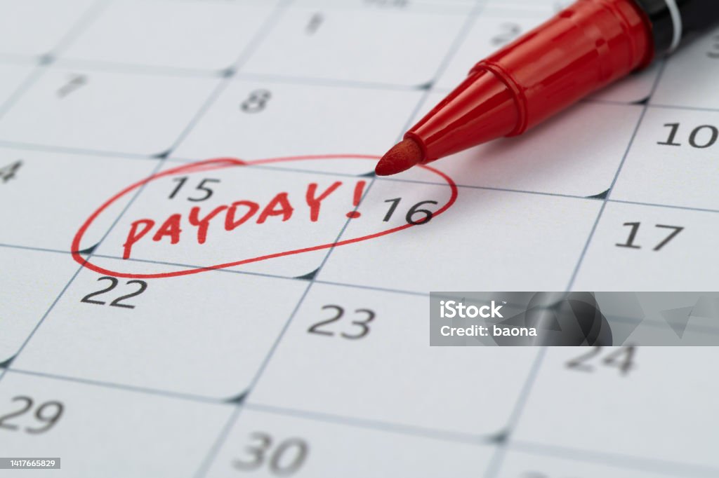 Calendar with red marked payday Paycheck Stock Photo