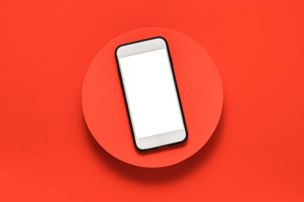 istock Blank screen mobile phone with clipping path on the red podium top view 1417665920
