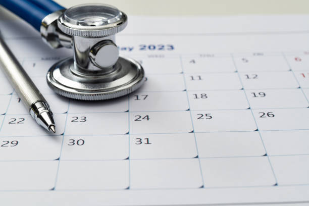 istock Stethoscope and pen on a calendar 1417670452