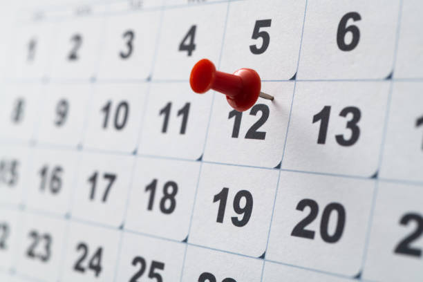 Embroidered pins on a calendar stock photo