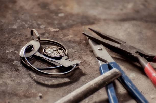 istock Closeup shot of pliers, other tools, and a key on a dusty surface 1417675636