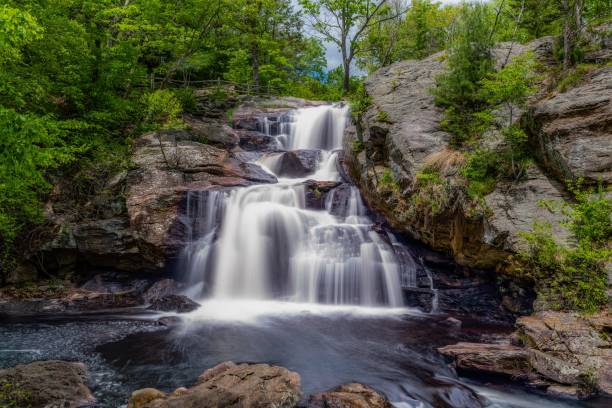 istock Silk effect water flowing down a rocky cascade in a forest 1417675679