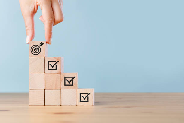 istock Goals achievement and business success. Hand holding cubes shows tasks completion 1417675729