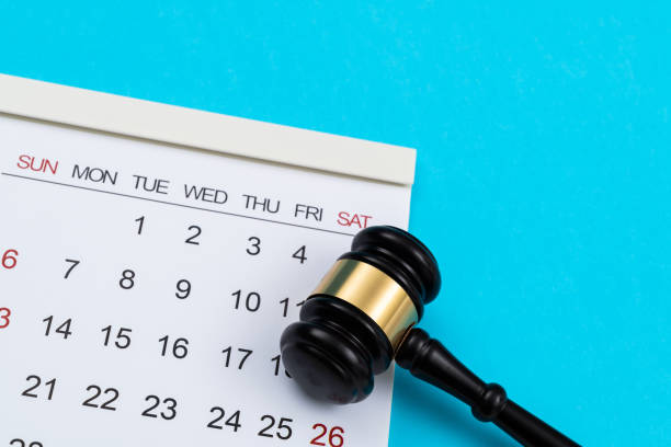 istock Calendar with gavel on blue background 1417676374