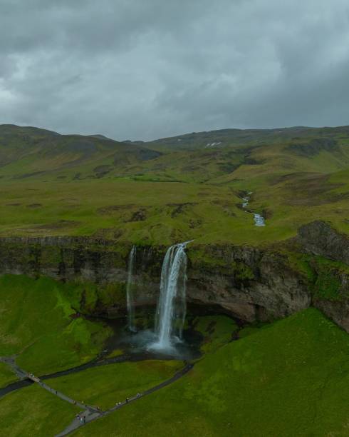istock Beautiful view of a huge waterfall from a cliff on a cloudy day 1417676652