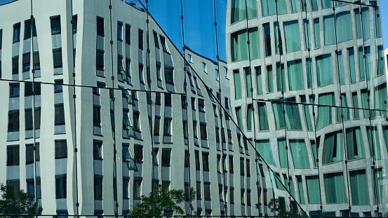 Singapore, Singapore - May 26, 2015: Reflection of skyscrapers in Central Business District of Singapore during daytime, showing busy vehicle traffic.