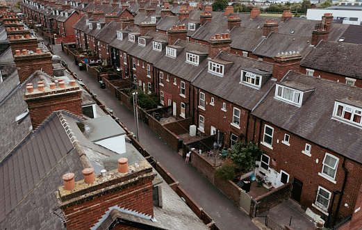 Leeds, UK - August 24, 2022.  Aerial view of the rooftops and houses of a run down Northern town in England during the UK Government's levelling up promise