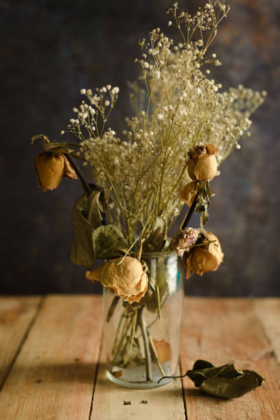 istock Vase with dried flowers on wooden table. 1417679821