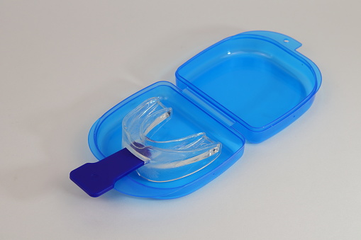 A mouth guard, anti snoring, with its blue handle