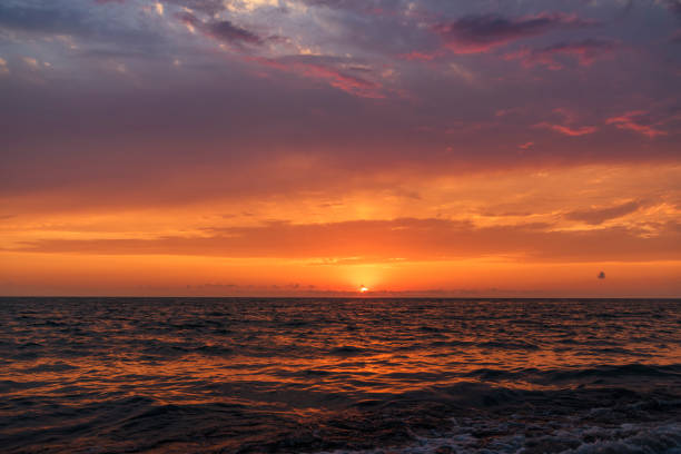 istock Beautiful sunset over the sea with bright orange clouds. 1417681937