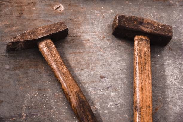 istock Closeup of rusty hammers on a wooden surface 1417685010