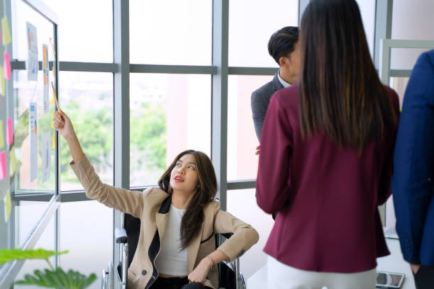 istock Disability woman is working with her team. 1417685528