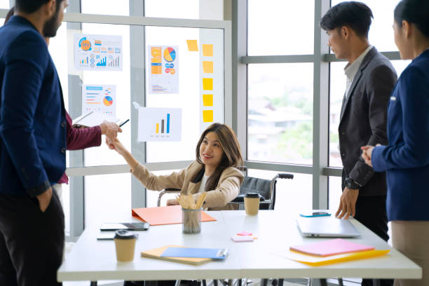 istock Disability woman is working with her team. 1417685529