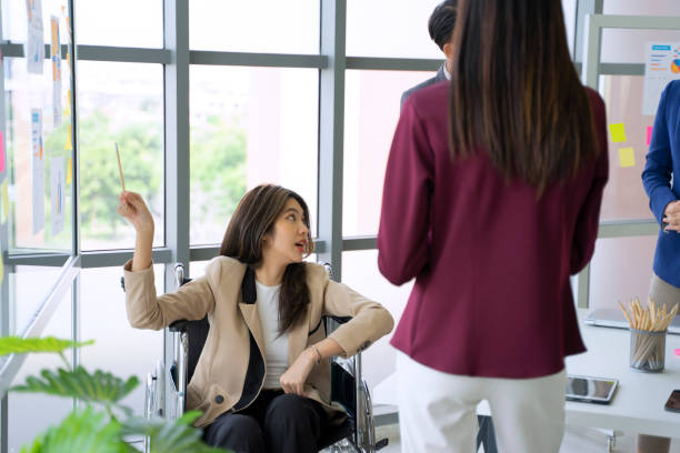 istock Disability woman is working with her team. 1417685539