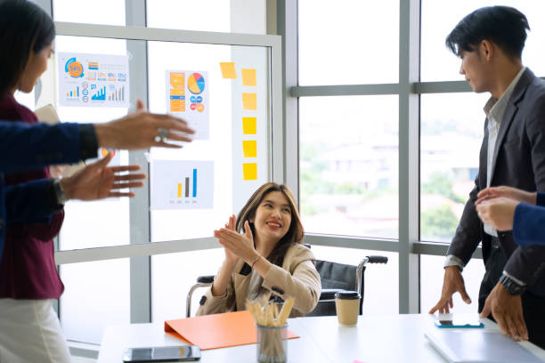 istock Disability woman is working with her team. 1417685583