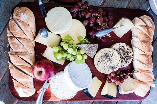 A top view of a charcuterie board with cheese and bread