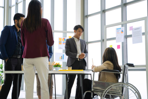 istock Disability woman is working with her team. 1417685914