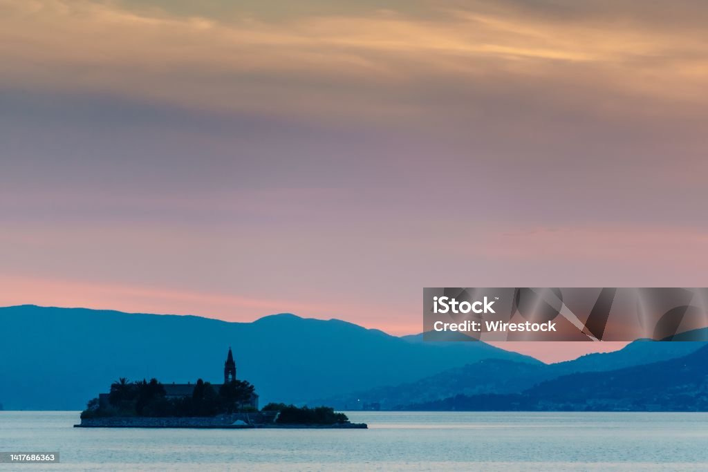View of Our Lady of Mercy at sunset. Gospa od Milosti, Montenegro. The view of Our Lady of Mercy at sunset. Gospa od Milosti, Montenegro. Beach Stock Photo