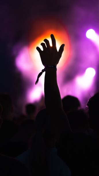 istock Hand silhouetted by lights and a smoke machine 1417686487
