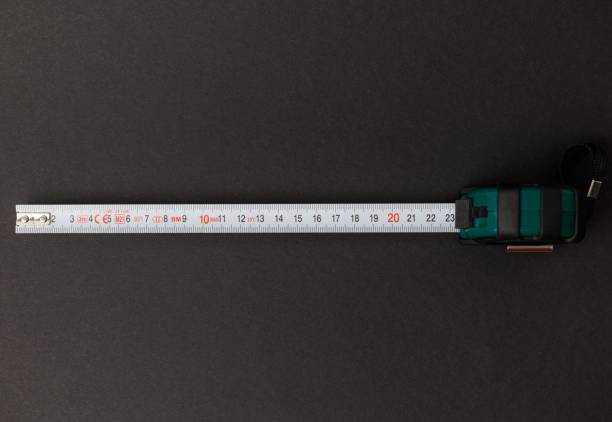 istock Measuring tape isolated on black background. 1417687046