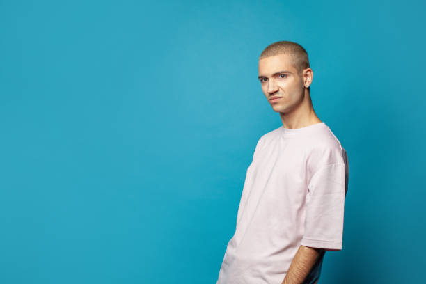 istock Sad unhappy young man standing on bright blue background 1417687368