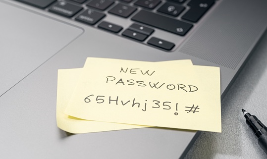 Change of password to a stronger one- Message on sticky note on laptop. Computer security management concept