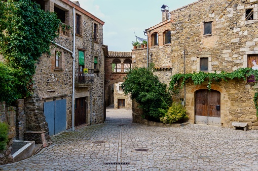 Tourists strolling in Corso Italia, for centuries the main street of Arezzo, mostly lined by historic buildings now hosting stores and bars