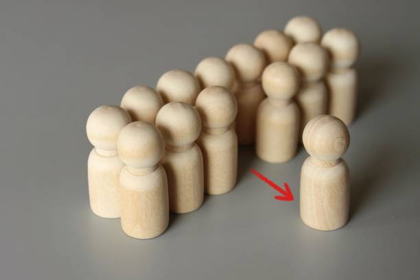 istock Selective focus image of one wooden doll leave the group. 1417692267