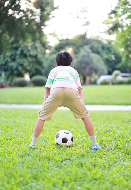 Kids playing football on grass