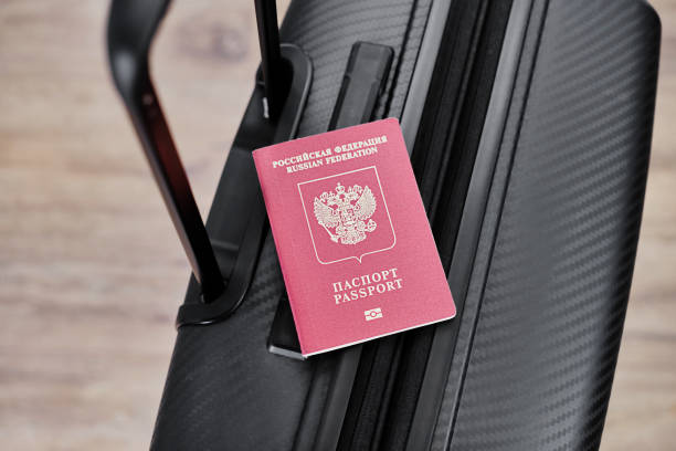 istock Russian passport on a black travel suitcase, top view, selective background. Emigration of Russians, seeking asylum 1417697462