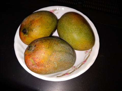 Delicious Mango Fruit are decorated in the Bowl. Mango is an edible stone fruit produced by the tropical tree Mangifera indica.