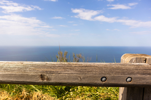 sky with clouds and sea seen from a wooden fence, Rimini, Italy. High quality photo