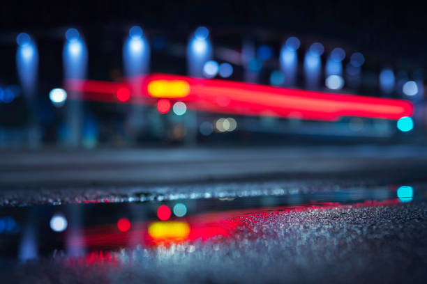 Street, facade and vehicle lights in the city at night.