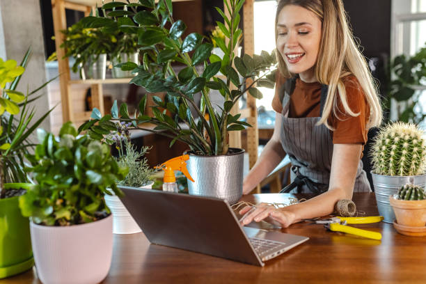 istock Beautiful woman looking online tutorial about gardening 1417705350