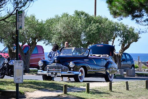 Sables-d'Or-les-Pins, France, July 5, 2022 - A 1948 Buick Super Eight convertible in a parking lot on the beach of Sables-d'Or-les-Pins, Brittany, France