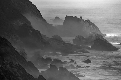 Hazy, Black and white, View along the jagged, seaside cliffs of the Tsitsikamma Mountains.