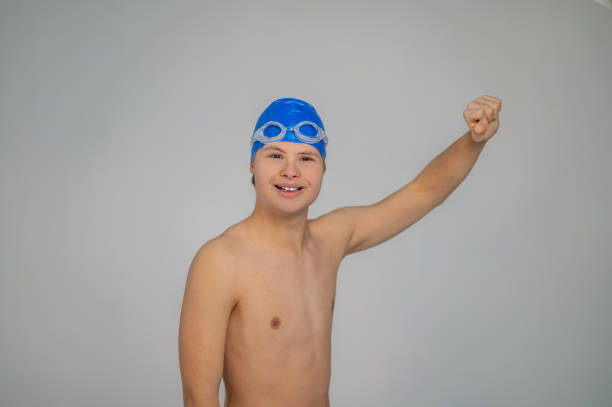 istock Boy in swimming hat doing moves before swimming 1417710147