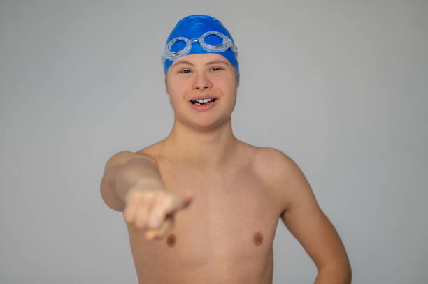 istock Boy in swimming hat doing moves before swimming 1417710152