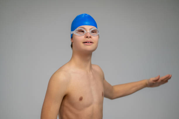 istock Boy in swimming hat doing moves before swimming 1417710155