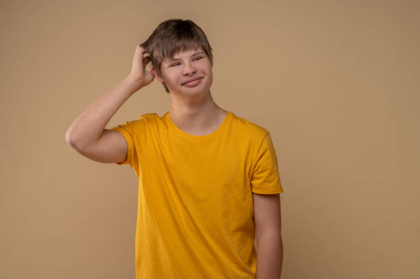istock Pleased teenage boy posing for the camera 1417710229