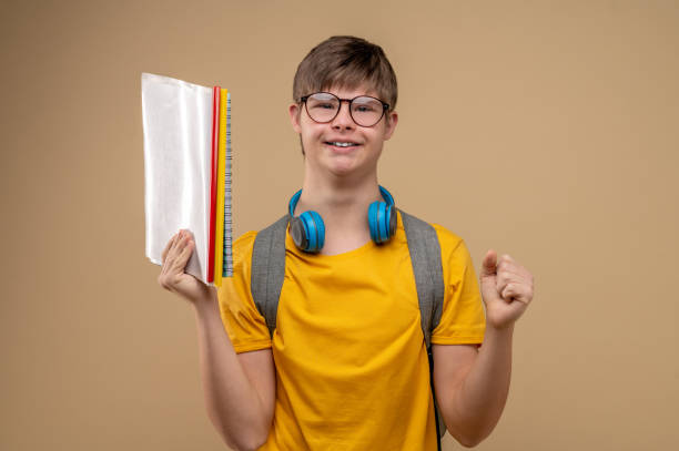 istock Happy schoolboy posing for the camera with his textbooks 1417710338