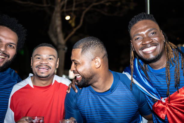 istock Soccer fan friends outdoors at night 1417712655