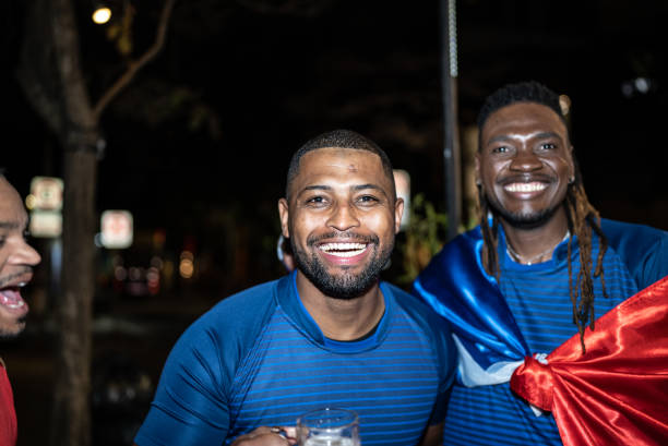 istock Soccer fan friends outdoors at night 1417712657