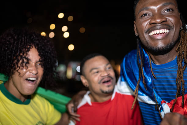 istock Soccer fans outdoors at night 1417712740