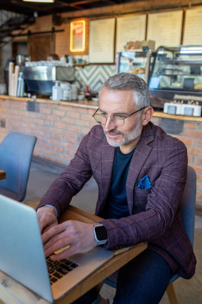 istock Businessman working in a cafe and looking seriosu 1417715071