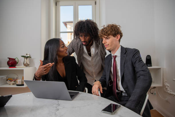 istock Colleagues discuss at work using a laptop, multi-ethnic business group. 1417719863