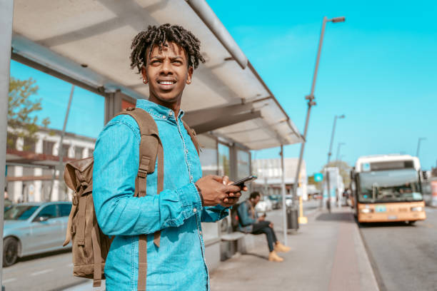 istock Man standing at bus stop looking ahead 1417720815